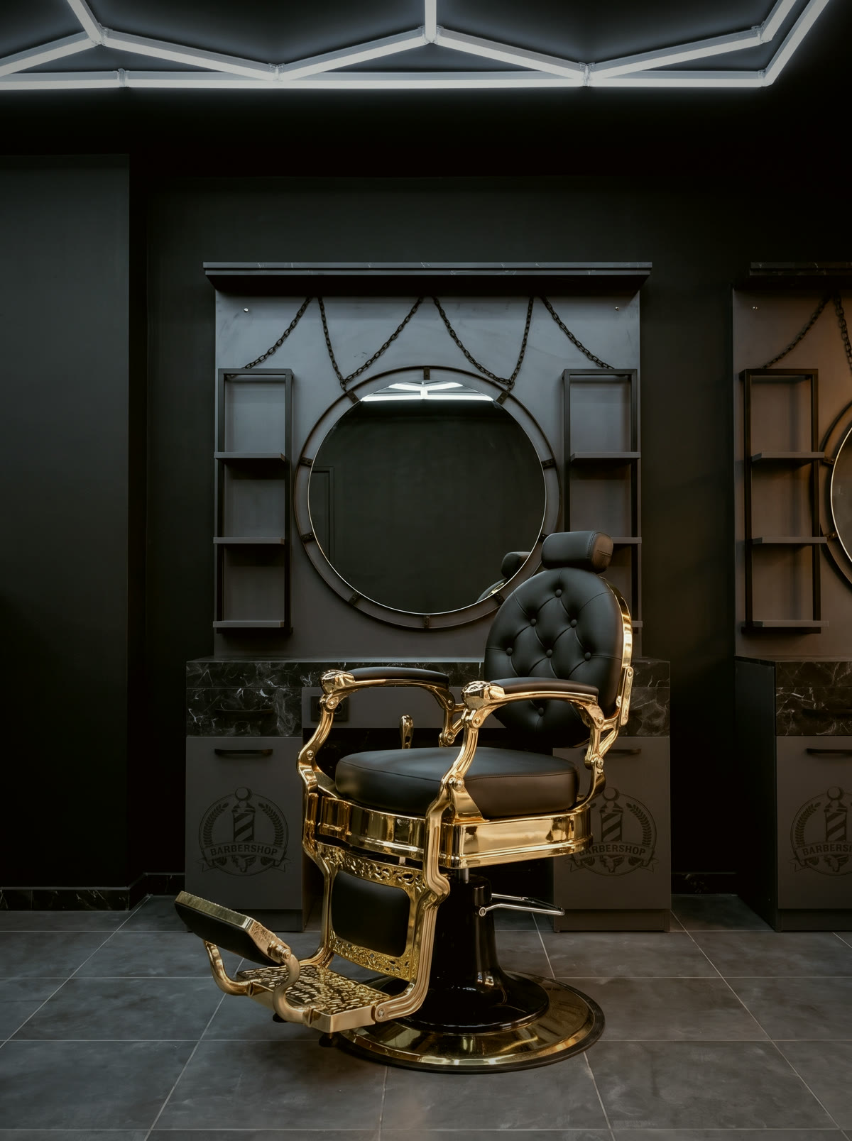 Fauteuil de barbier doré devant un miroir rond au salon Royal Coiff